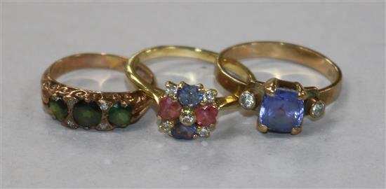 An 18ct gold and gem set ring set with heart shaped stones and two 9ct gold and gem set rings.